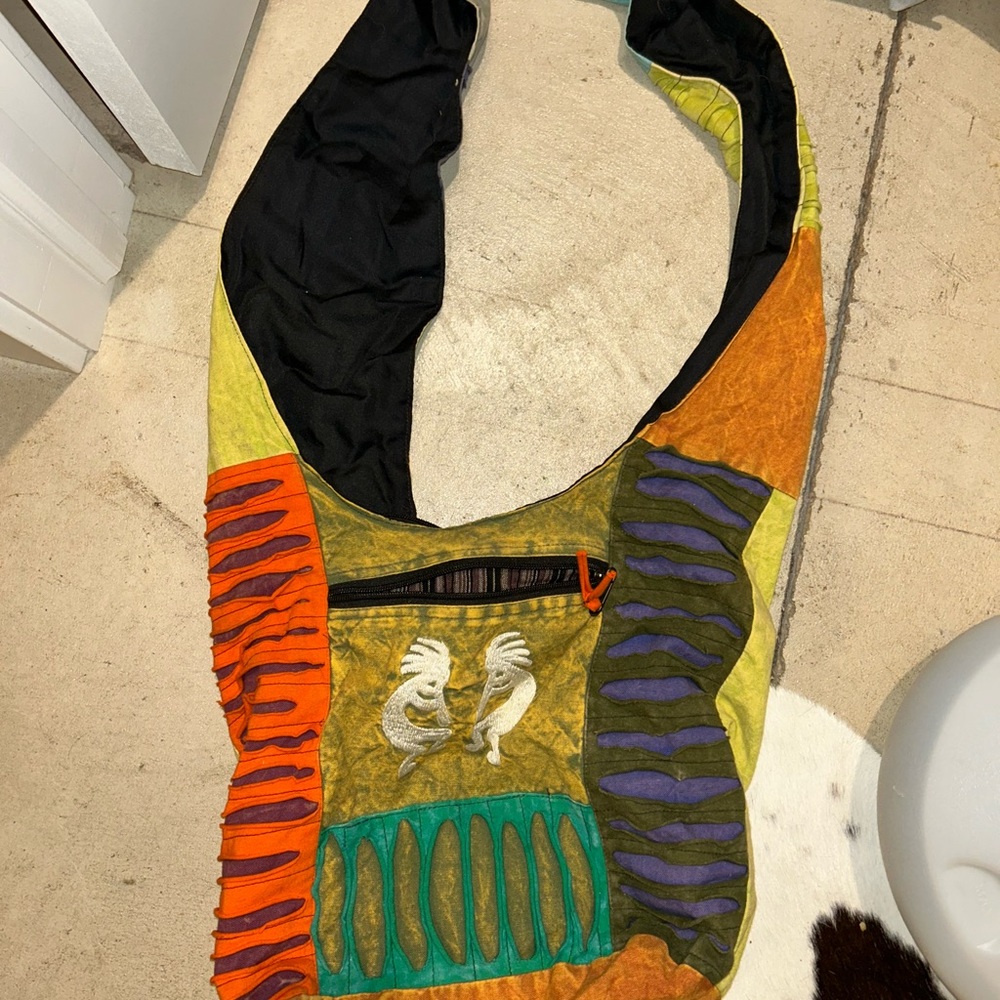 Vibrant Orange and Yellow Shoulder Bag with Kokopelli Design